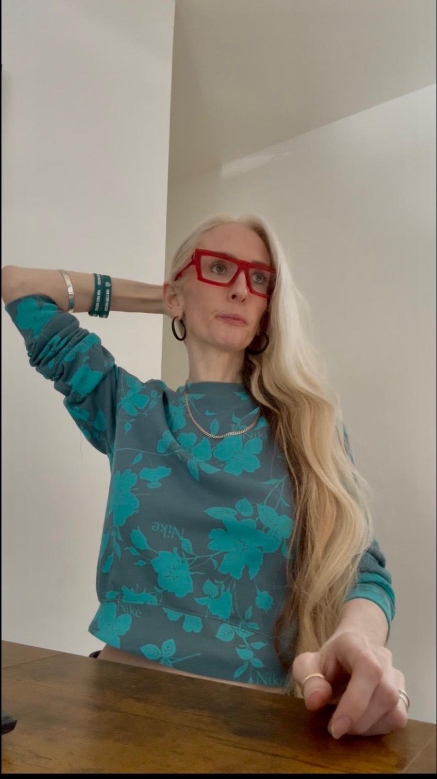 Louise Anna Ede, host of the Brave Everyday Podcast, in her signature red glasses and Brave Everyday wristbands
